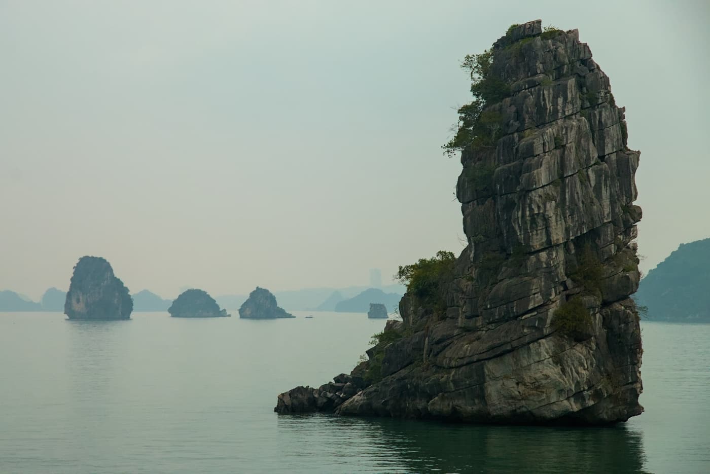 Limestone pillars scattered across a calm stretch of bay