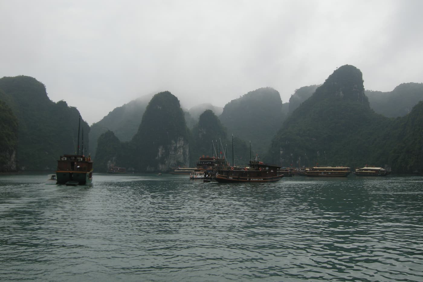 Early-morning mist over karsts and junks