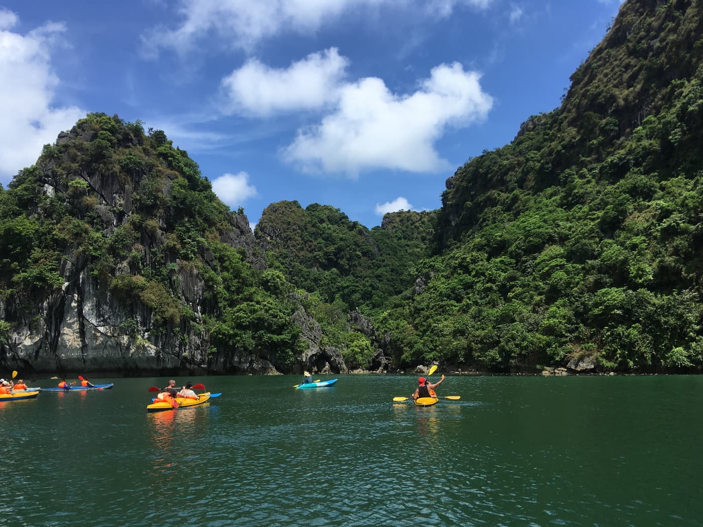 Kayakers paddling between steep karst islands